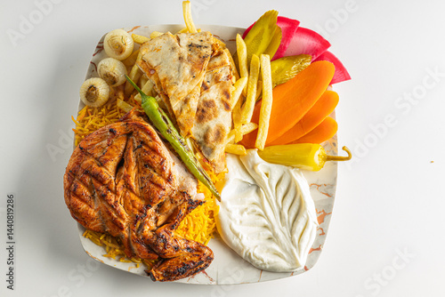 Grilled Chicken with French Fries, Flatbread, and Vegetables on a Plate Isolated on White Background

