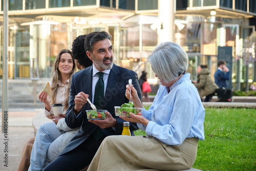 Obraz na płótnie Multi ethnic business team enjoying a healthy lunch break together outdoors w salonie