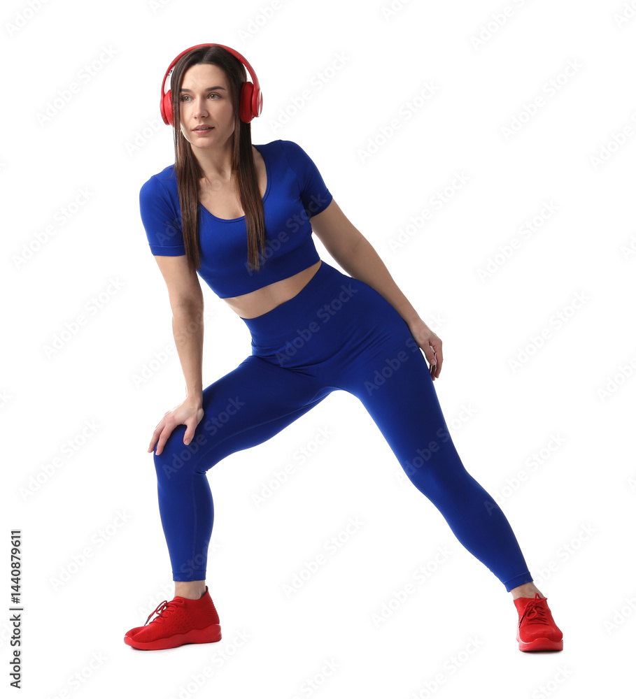 Woman in sportswear with headphones posing on white background Woman in sportswear with headphones posing on white background