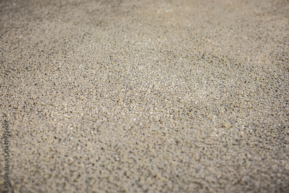 Detailed view of a textured surface made of small, evenly distributed pebbles, likely part of a flooring or underfloor heating construction process. Detailed view of a textured surface made of small, evenly distributed pebbles, likely part of a flooring or underfloor heating construction process.
