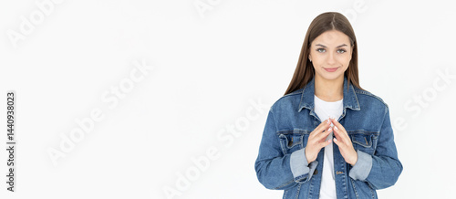 I have great evil plan. Confident and tricky woman in white t-shirt and jeans coat, holding fingers together and smirking at camera, having some bad intention in mind, planning to commit crime