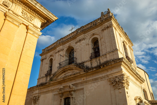 Beautiful tower of the Baroque Church of Santa Chiara in Noto, Sicily, Italy, a UNESCO World Heritage Site, with golden sunset light