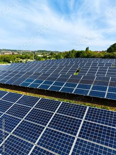 Rows of solar panels on farmland generating renewable and clean energy for business