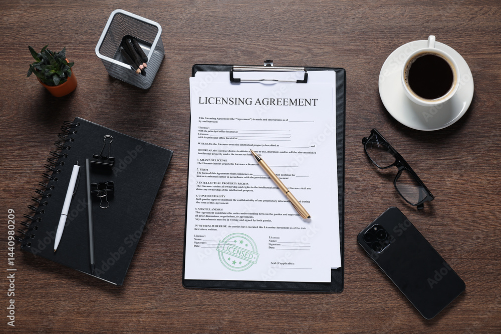 Flat lay composition with licensing agreement document on wooden table Flat lay composition with licensing agreement document on wooden table