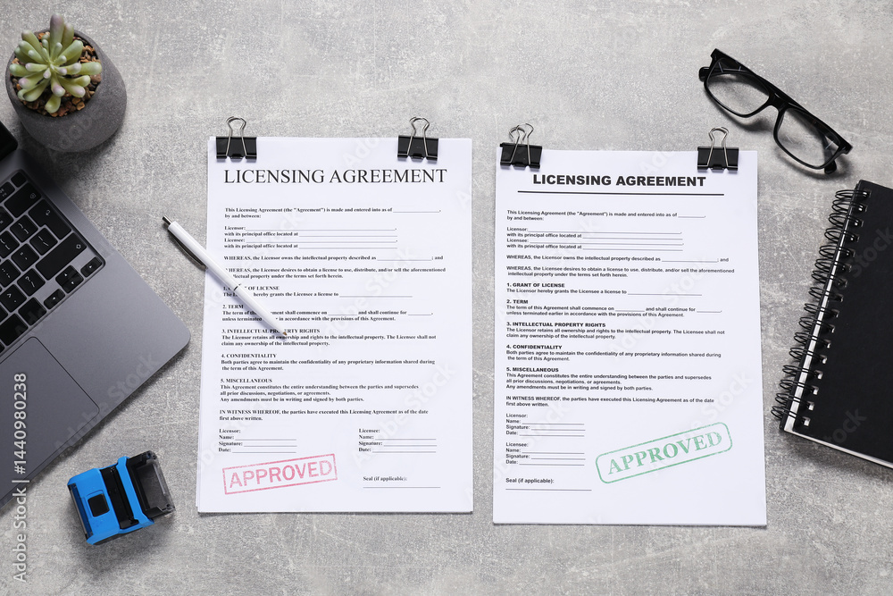 Flat lay composition with licensing agreement documents on gray textured table