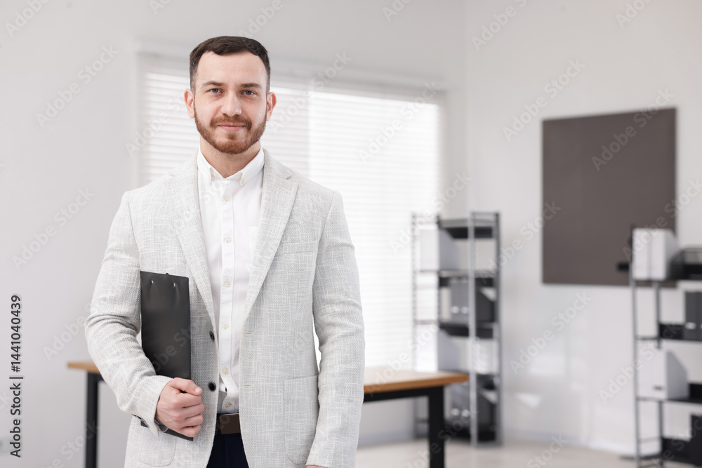 Fototapeta premium Happy recruiter with clipboard in office, space for text