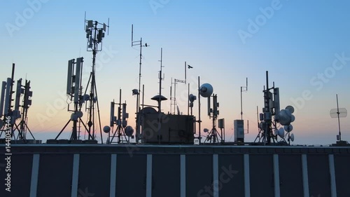 Rooftop base station antennas emitting electromagnetic radiation waves