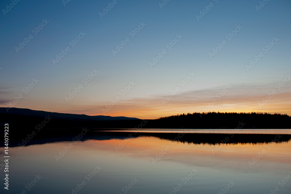 Fototapeta premium Panorama of dawn fire in the sky above the natural pasture. Golden red clouds just before sunrise. Picturesque landscape at sunrise. Beauty in nature