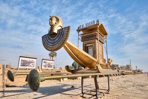 Schilderij op canvas Luxor, Egypt - December 26 2023: A royal boat installed on the avenue of sphinxe