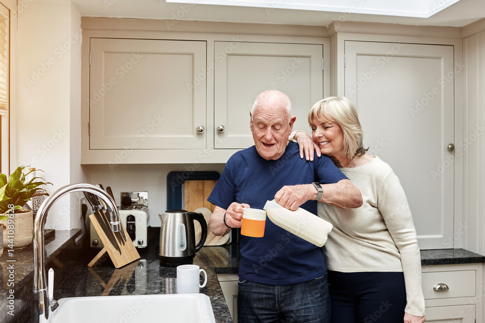 Fototapeta premium Senior, couple and pouring milk in kitchen with smile for coffee, break or beverage in the morning at home. Elderly, man and woman with tea for breakfast, happiness and bonding in house or apartment