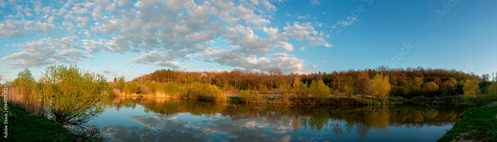 Panorama of forest lakes in spring, young leaves and freshly blossomed buds of trees and shrubs Panorama of forest lakes in spring, young leaves and freshly blossomed buds of trees and shrubs