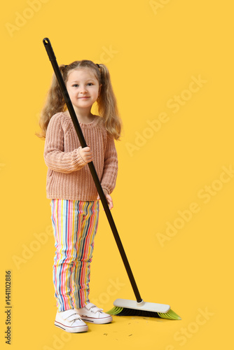 Cute little girl sweeping w...