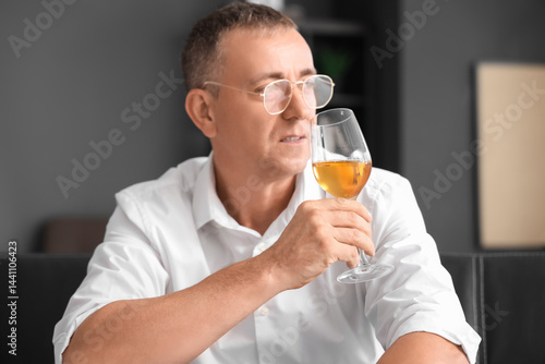 Mature man tasting wine at ...