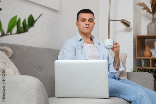 Handsome young man with cup...