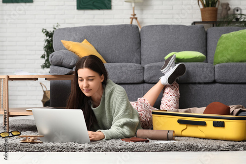 Young woman using laptop ne...