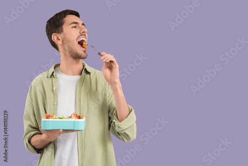 Young man with lunchbox on ...