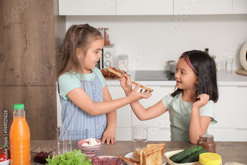Cute little girls eating ta...