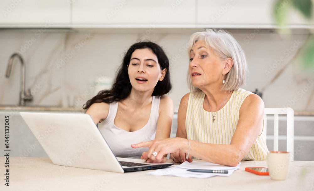 Mature woman consulting with female real estate agent in home interior Mature woman consulting with female real estate agent in home interior