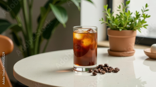 glass of iced coffee on a minimalist table, surrounded by subtle decorative elements like coffee beans and a small plant, copy space
