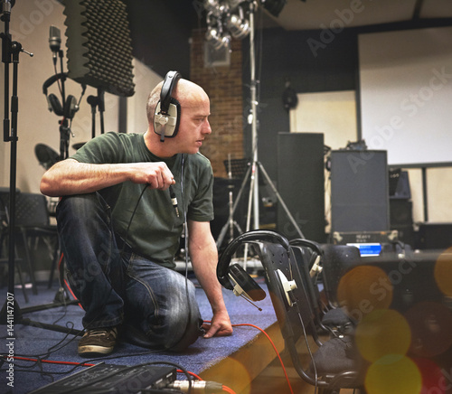 Принти на полотні Audio technician, headphones and man with cable at stage to test system, equipment or installation