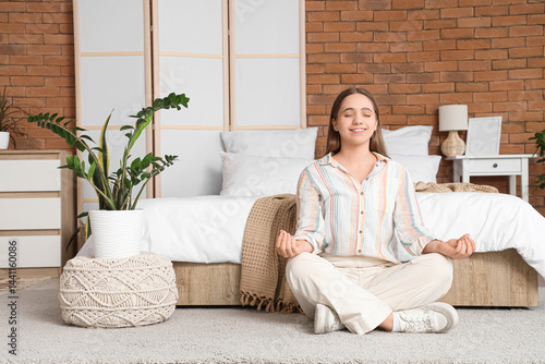 Pretty young woman meditati...