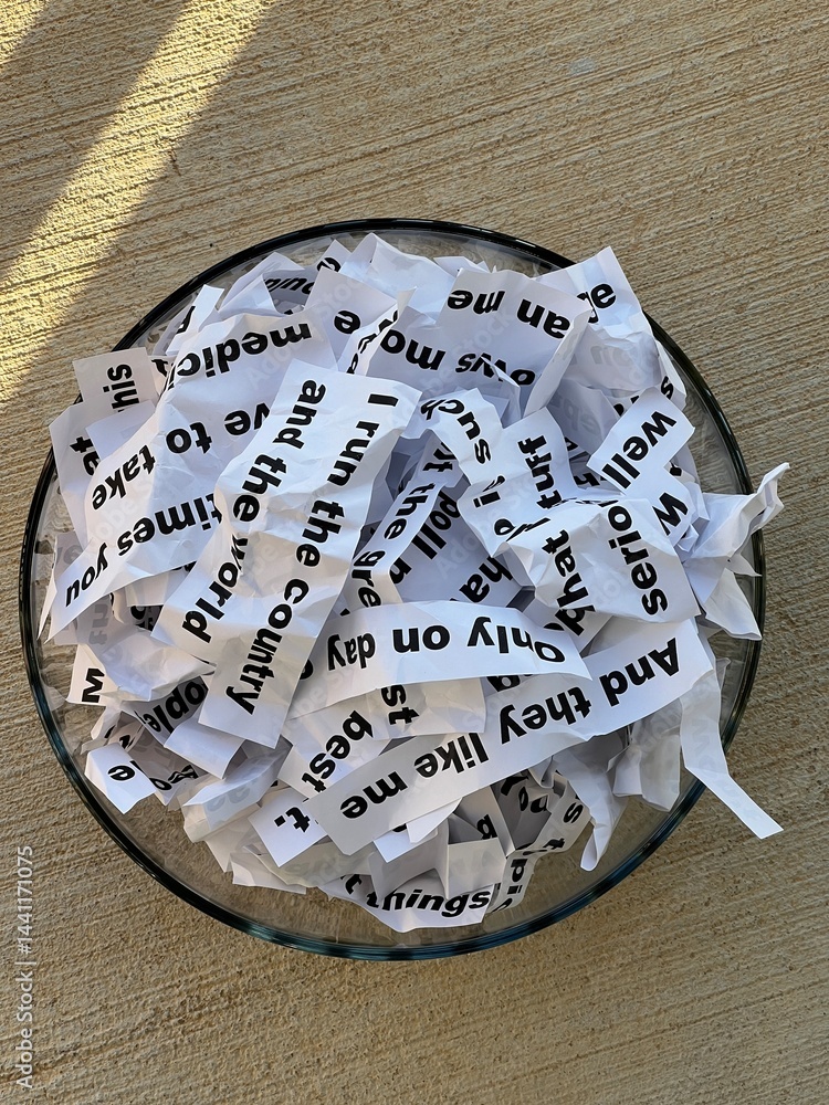Word salad jumble of crumpled strips of paper with words and phrases