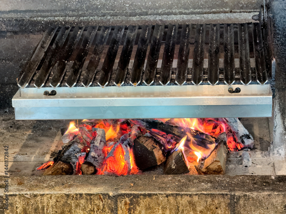 Real wood stove with glowing fire and hot ash coal ready to grill