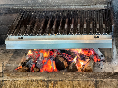 Obraz na płótnie Real wood stove with glowing fire and hot ash coal ready to grill w salonie
