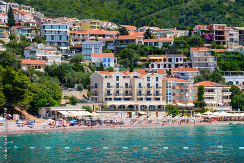 Obraz na płótnie Beachfront hotels on Sveti Stefan Beach near Budva on the Montenegrin riviera, along the coast of the Adriatic Sea w salonie