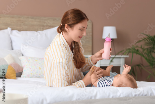 Mother with bottle of milk ...