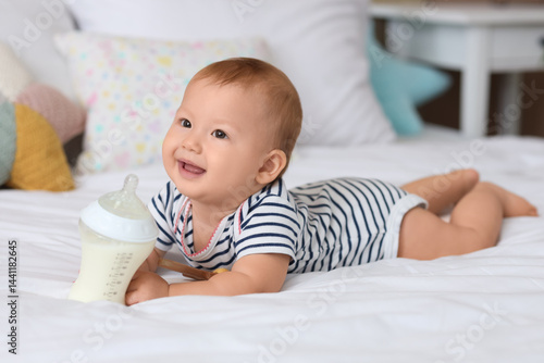 Cute baby with bottle of mi...