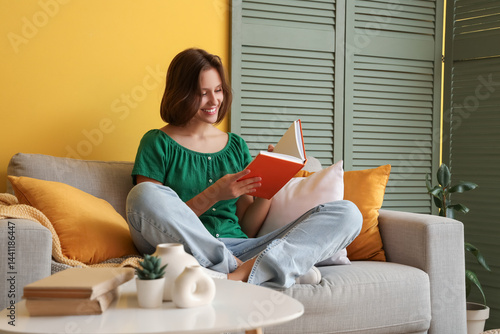 Pretty young woman reading ...