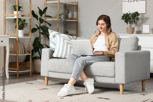 Young woman in headphones u...