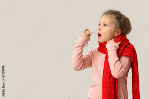 Sick little girl spraying h...