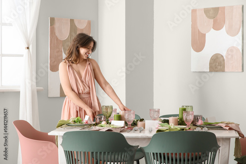 Young woman setting elegant...