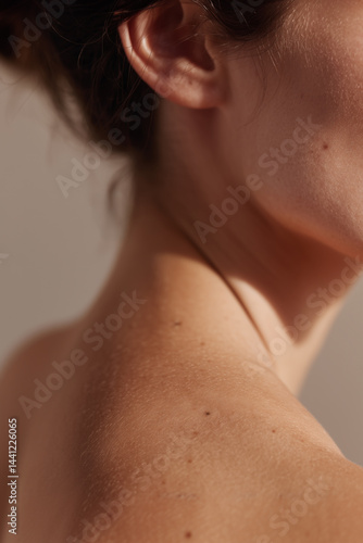 Skin Closeup of Woman Shoulder and Neck with Natural Moles and Soft Light for Beauty Concept