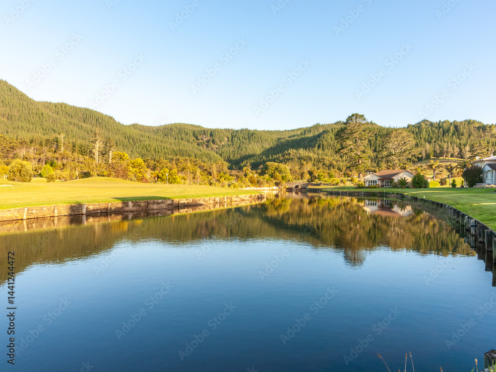 Calm reflective water of waterway through idyllic landscape Calm reflective water of waterway through idyllic landscape