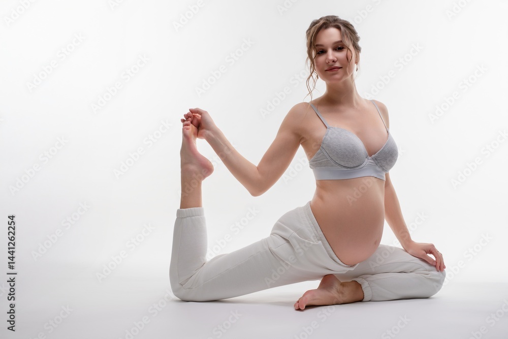 Fototapeta premium Beauty and elegance of a pregnant woman in a graceful pose