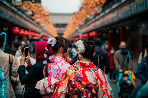 Young girl wearing Japanese kimono standing in front of Sensoji Temple in Asakusa Tokyo, Japan. Kimono is a Japanese traditional garment.