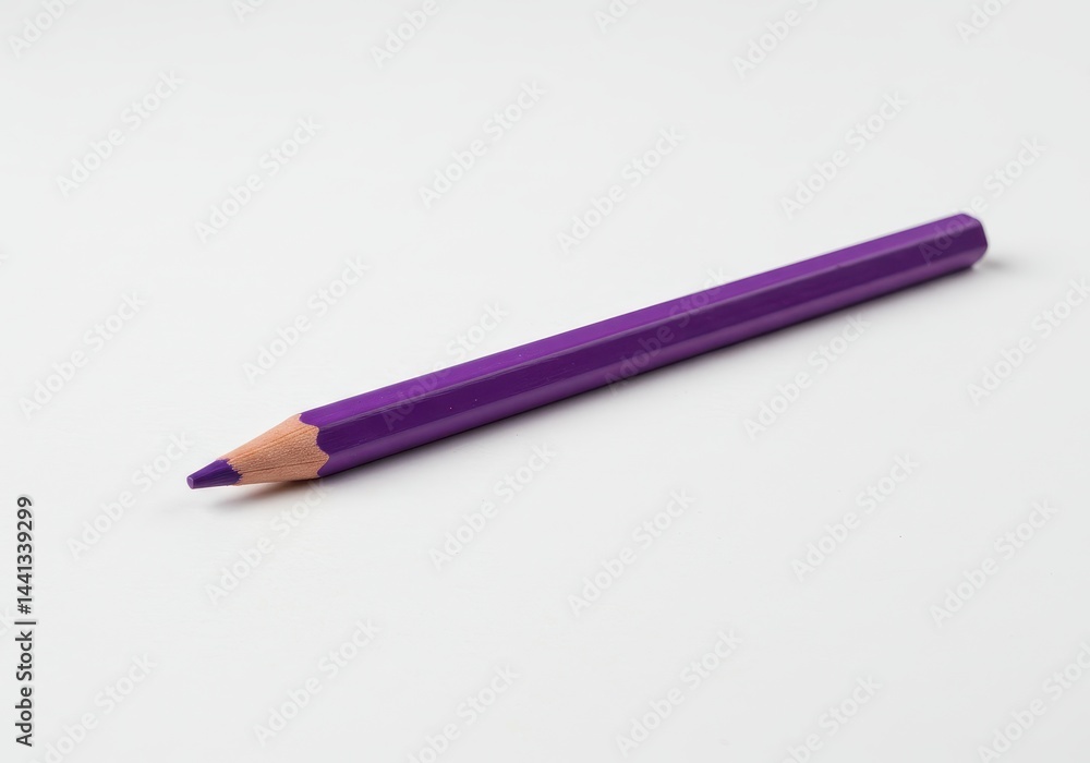 A single purple colored pencil lying on a plain white surface in a horizontal position close up view A single purple colored pencil lying on a plain white surface in a horizontal position close up view
