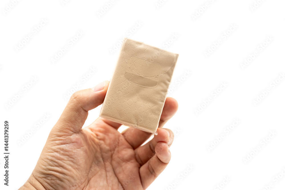 Hand holding mini Brown tissue paper pack isolated on white background.