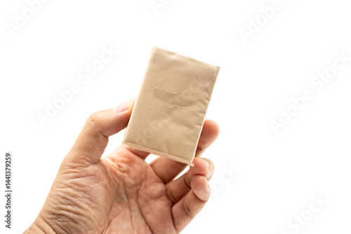 Obraz na płótnie Hand holding mini Brown tissue paper pack isolated on white background. w salonie