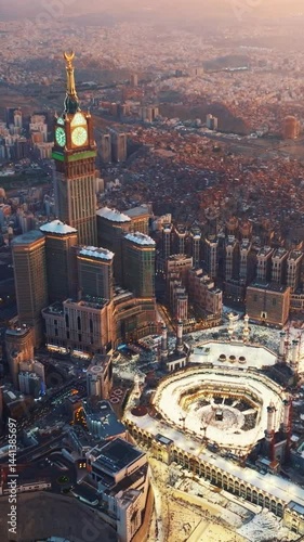 Majestic aerial view of the Grand Mosque and towering Abraj Al Bait Clock Tower in Mecca, Saudi Arabia bathed in the warm light of sunrise