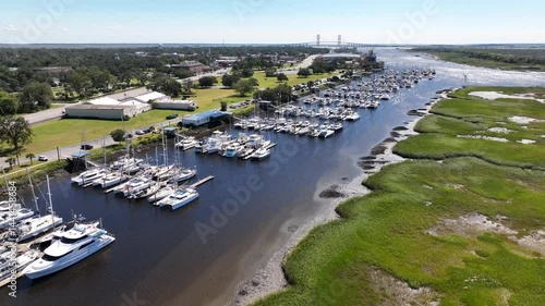 Boats docked in marina beside coastal wetlands in Brunswick, Georgia on a beautiful sunny day in summer