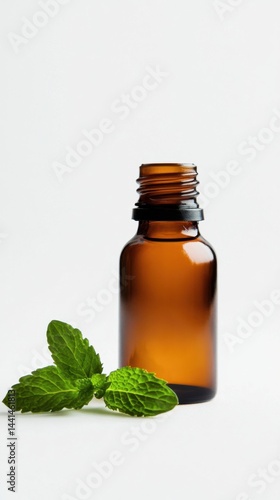 Amber bottle with fresh mint leaves on a white background showcasing aromatherapy essence and natural remedy for wellness and spa treatment in a minimalist style
