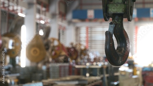 Fotografie Closeup of swivel chain hook crane of electric hoist in factory workshop, puller