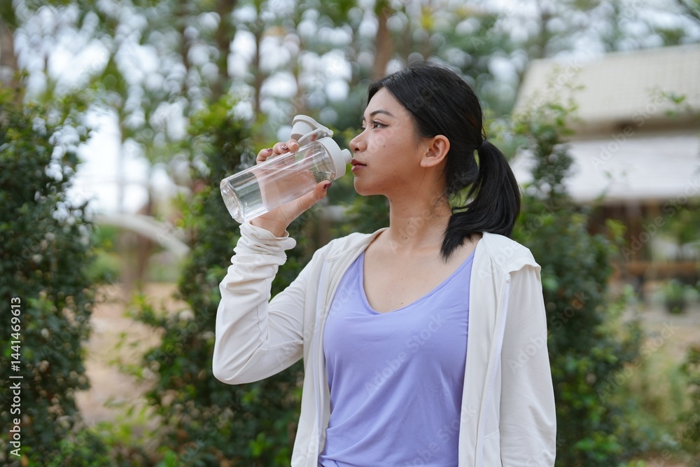 Asian women after running in outdoor Healthy active lifestyle beautiful girl drinking fresh water outdoor. Asian women after running in outdoor Healthy active lifestyle beautiful girl drinking fresh water outdoor.