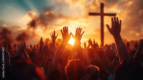 crowd of people raising hands towards a large wooden cross at sunset with vibrant orange sky and clouds evoking a sense of hope and unity