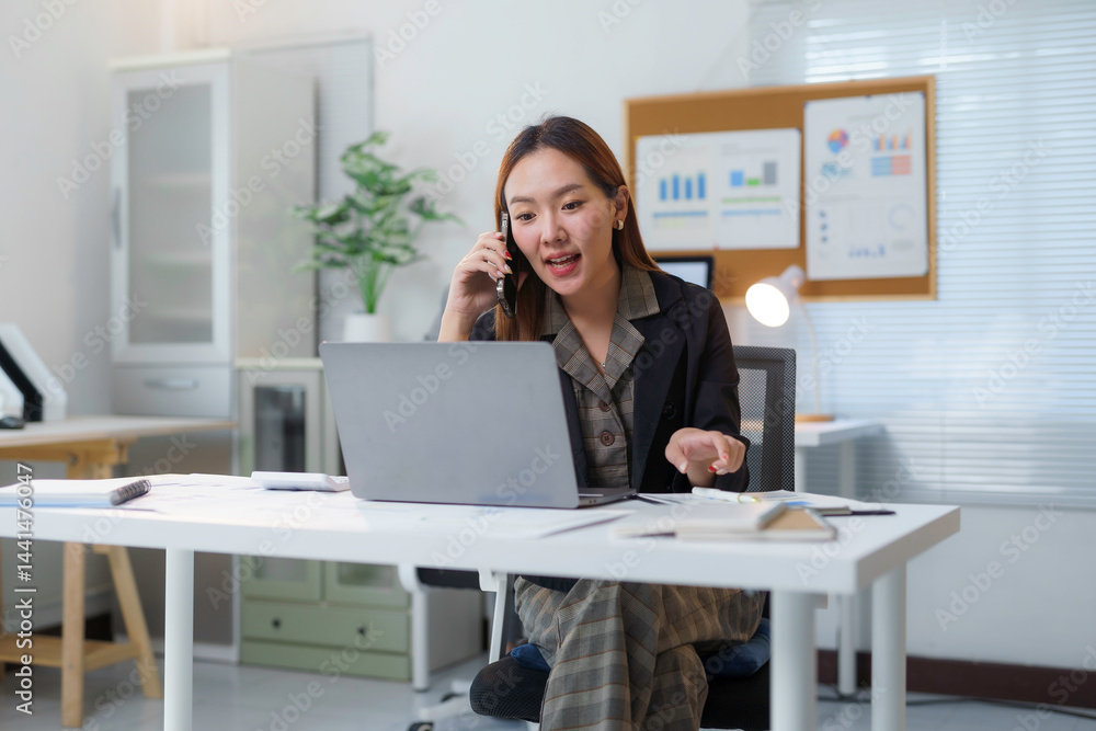 Young professional managing business operations remotely, using technology to enhance productivity and communication in a modern workspace