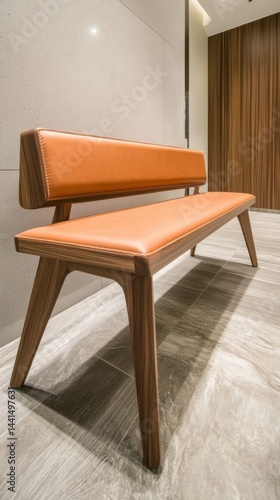 Elegant wooden bench with orange leather upholstery showcasing modern design and refined craftsmanship in a minimalist interior setting with warm lighting